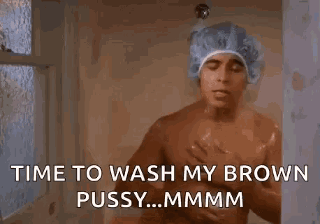 a man is taking a shower with a shower cap on his head and says `` time to wash my brown pussy ... mmmm '' .