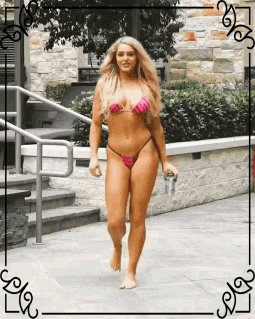 a woman in a bikini is walking down a sidewalk