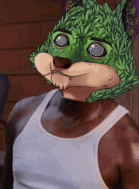 a man wearing a white tank top has a green animal mask on his face