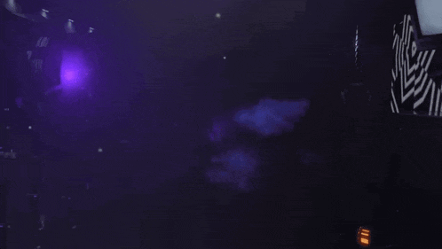 a dark room with a purple light coming out of it
