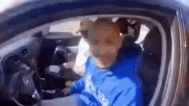 a blurry picture of a person driving a car .
