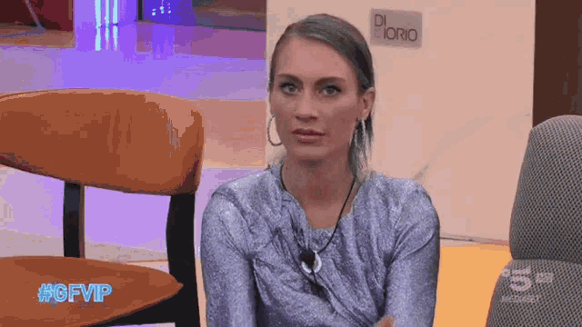 a woman sitting in a chair with the hashtag #gfvip on the screen