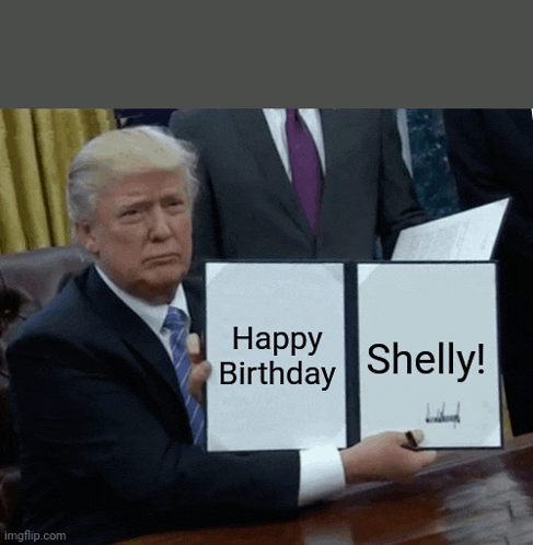 a man in a suit and tie is holding up a sign that says happy birthday shelly