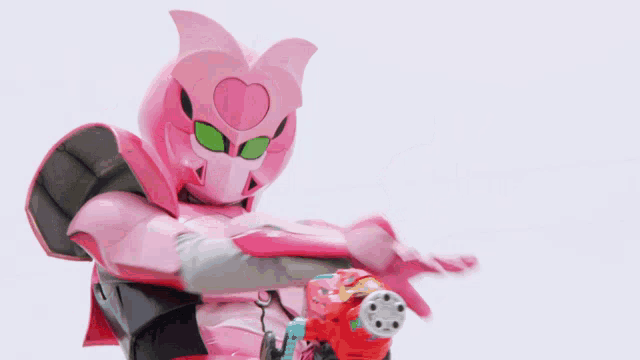 a pink robot is holding a red gun .