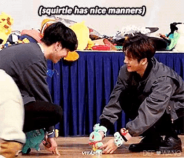 two men are playing with a stuffed animal and one of them says squirtle has nice manners