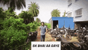 a man standing in front of a bunch of motorcycles with the words sk bhai aa gaye on the bottom