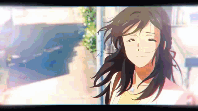 a close up of a woman 's face with her eyes closed and her hair blowing in the wind