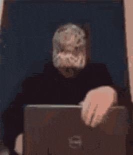 a blurry picture of a man using a laptop computer