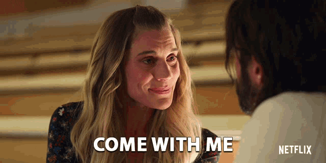 a woman says come with me while looking at a man 's face