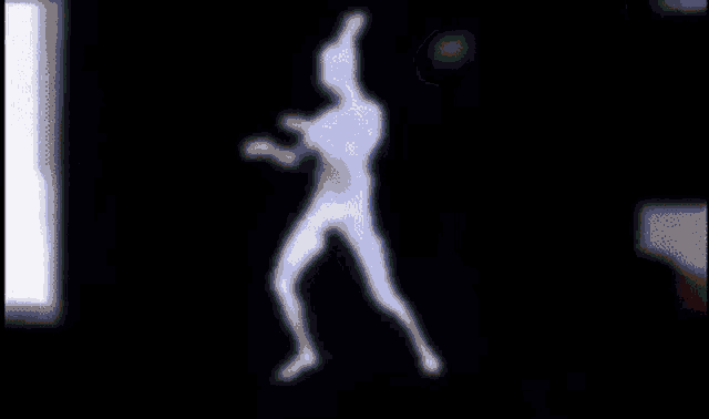a silhouette of a person in a dark room with a light behind them
