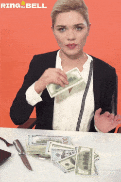 a woman is sitting at a table with stacks of money and a knife and the words ring the bell behind her