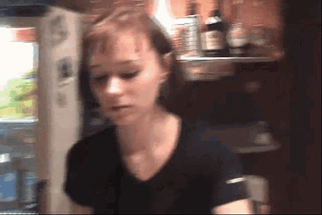 a blurred image of a woman in a black shirt