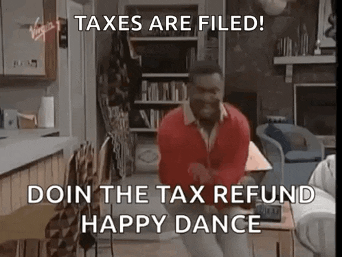 a man in a red jacket is dancing in a living room .