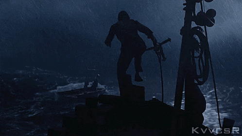 a man on a boat in the rain with the letters kvvcsr on the bottom right