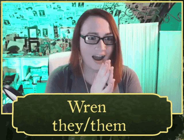 a woman with glasses and a sign that says wren they them on it