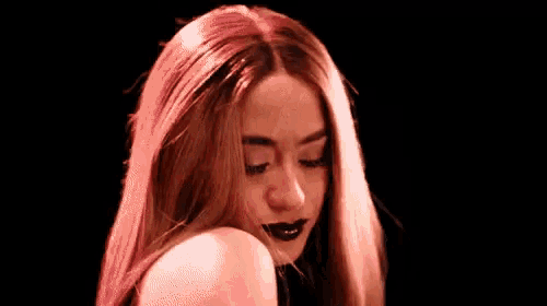 a woman with red hair is making a face with her mouth open .