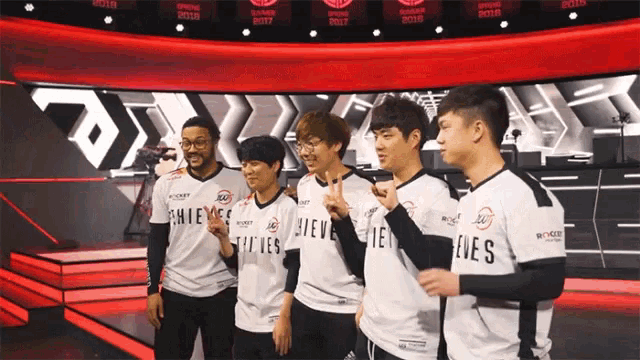 a group of young men wearing white shirts that say thieves