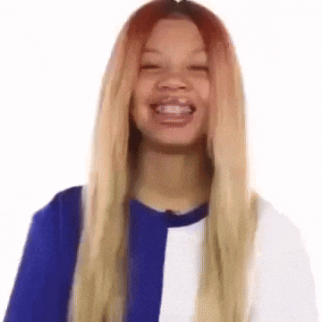 a woman with long blonde hair is smiling and wearing a blue and white striped shirt .