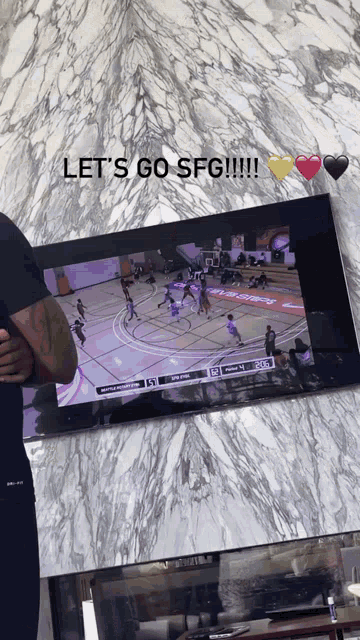 a man is watching a basketball game on a television with the words let 's go sfg