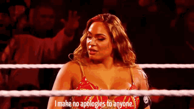 a woman is standing in a wrestling ring and saying `` i make no apologies to anyone . ''