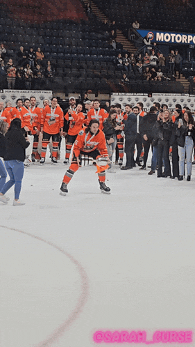 a group of hockey players are on the ice in front of a banner that says motorpoint