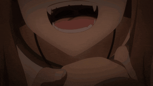 a close up of a person 's mouth with fangs visible