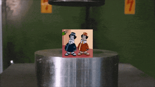 a picture of two cartoon characters is being pressed against a metal cylinder