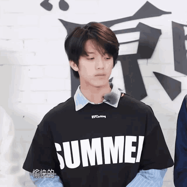 a man wearing a black shirt that says summer