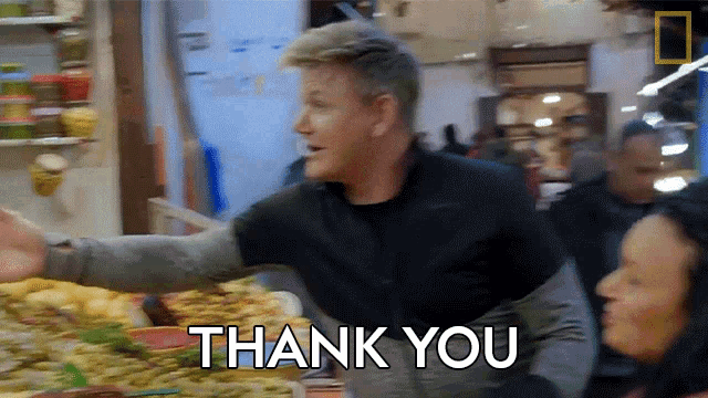 a man in a black jacket says thank you in front of a woman