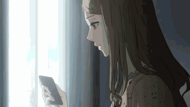a girl with long hair is looking at a cell phone