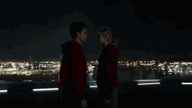 a man and a woman are looking into each other 's eyes