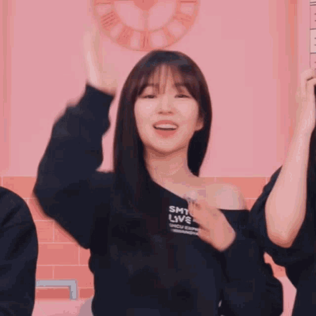 a girl wearing a smtown live sweatshirt smiles