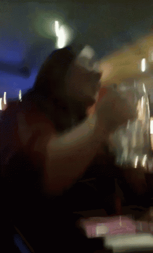 a blurry image of a person sitting at a table