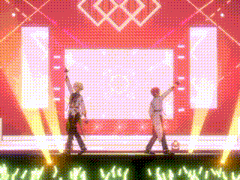 two men are standing on a stage with their hands in the air .