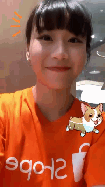 a girl wearing an orange t-shirt that says ' erobe ' on it