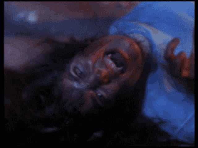 a man is laying on his back with his mouth open