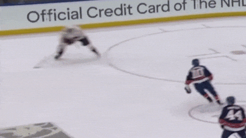 a hockey game is being played in front of an ad for the official credit card of the usa