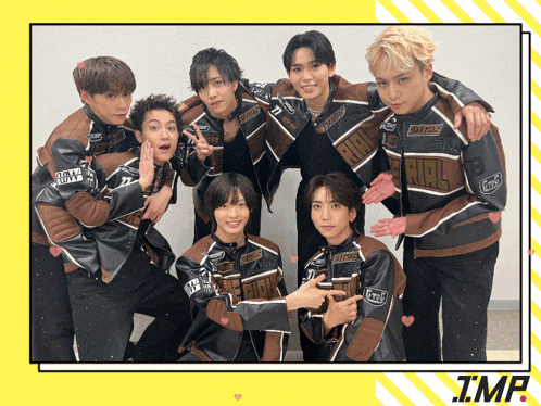 a group of young men are posing for a picture and one of their jackets has the word rival written on it