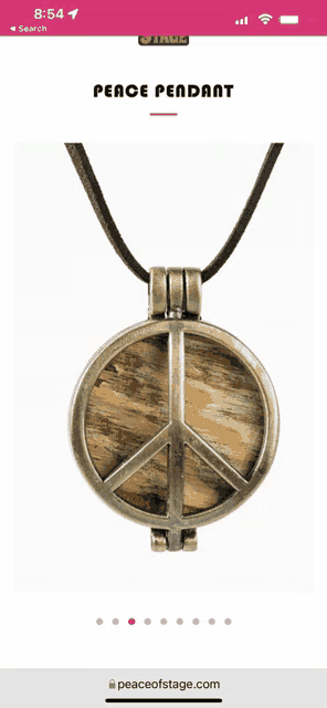 a phone screen shows a peace sign pendant