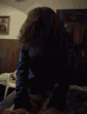 a blurry photo of a person 's face in a dark room