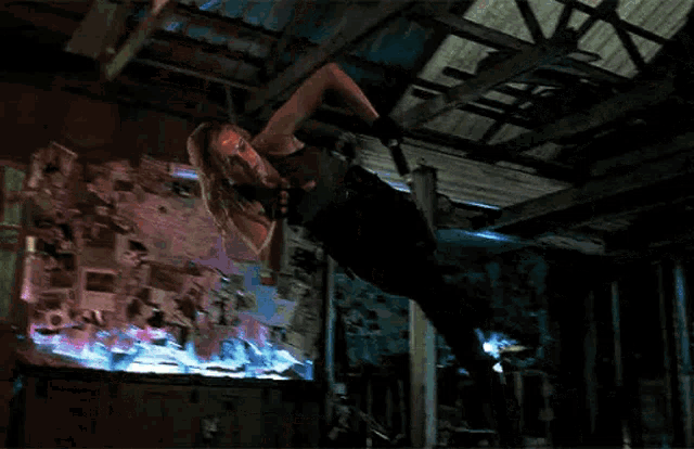 a woman is hanging upside down from a ceiling