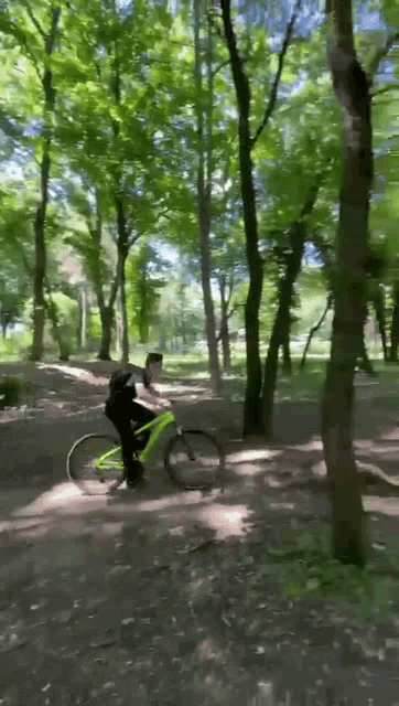 a person is riding a bike through a forest