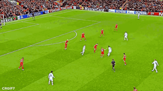 a soccer game is being played on a field sponsored by heineken
