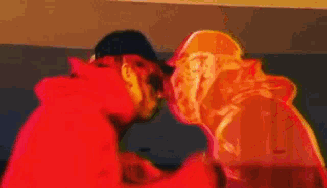a person in a red hoodie is standing next to a person in a pink hoodie in a video game .