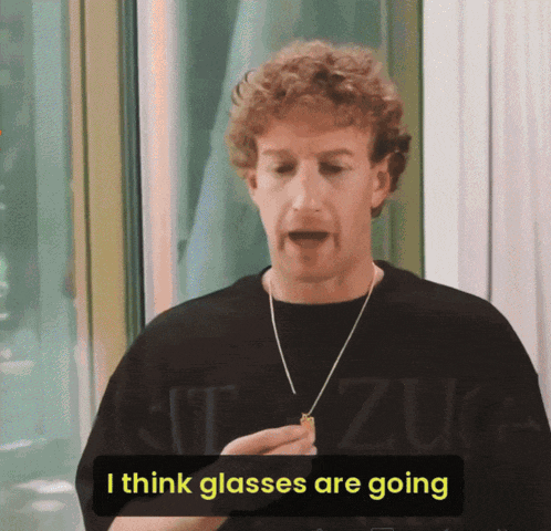 a man wearing a black shirt that says ' i think glasses are going '
