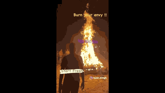 a man stands in front of a large fire with the words burn your envy on it