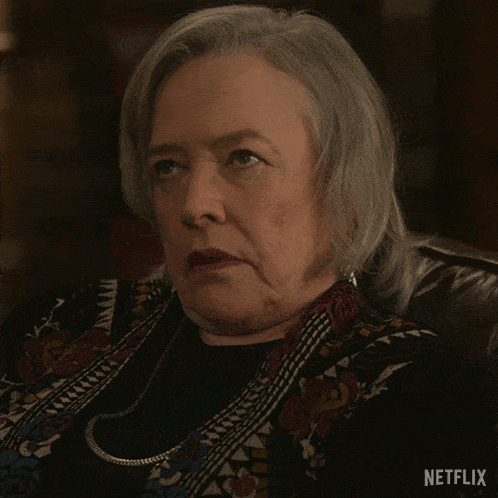 a woman is sitting in a chair with a netflix logo on the bottom right
