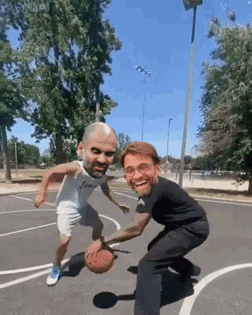 two men are playing basketball on a court and one of them is wearing a jersey that says juventus