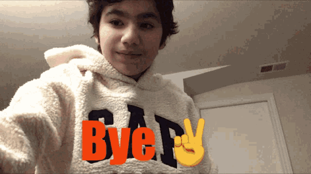 a boy wearing a hoodie that says gap bye