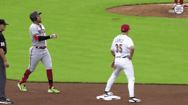a baseball player with the number 35 on his jersey stands on the base